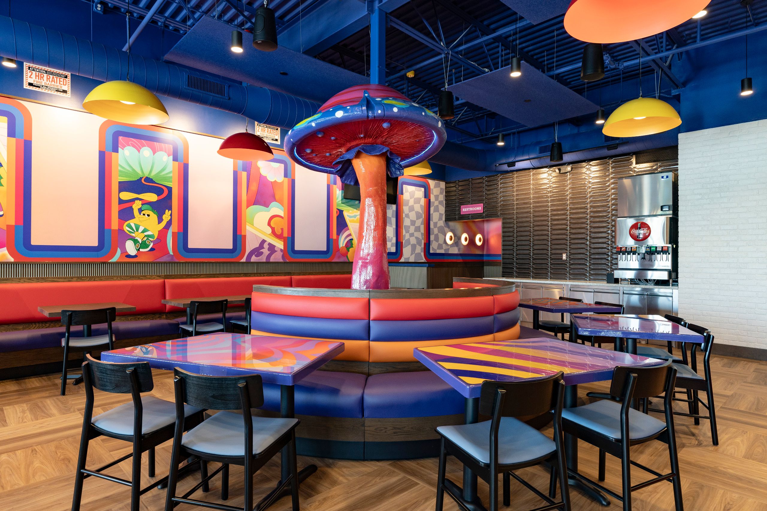 mellow mushroom newnan interior with colorful murals and mushroom sculpture