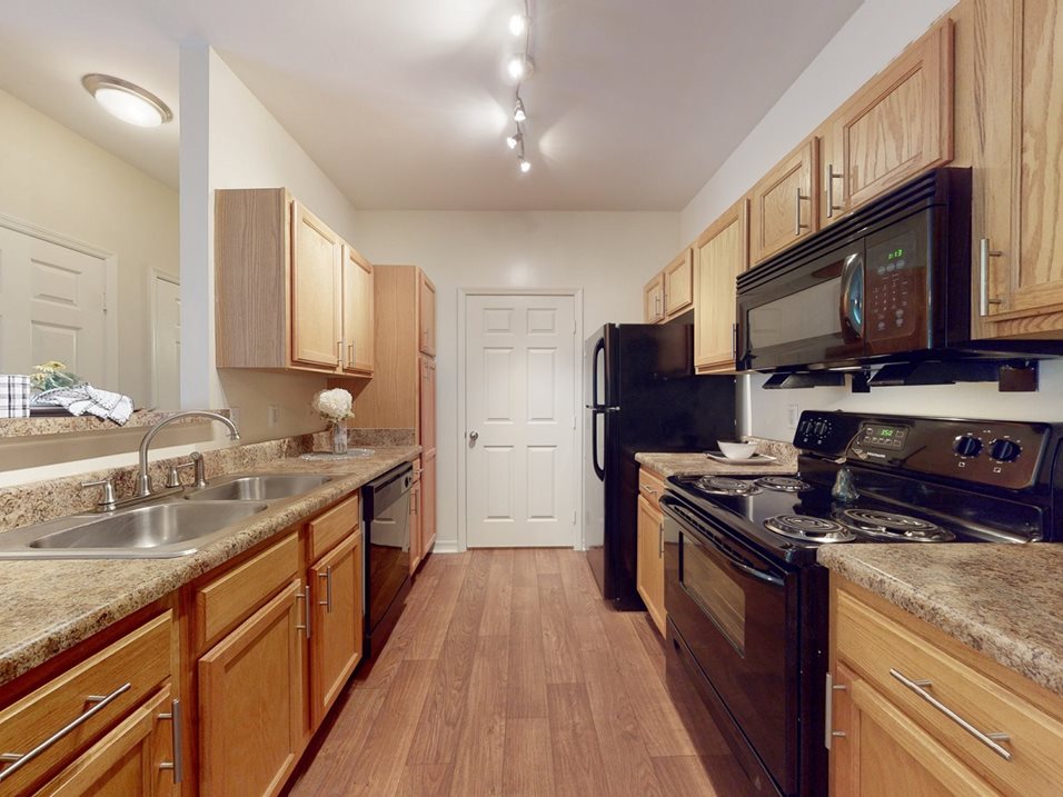 Gorgeous renovated kitchens available with updated counters and cabinetry at Parc 1346 Apartments