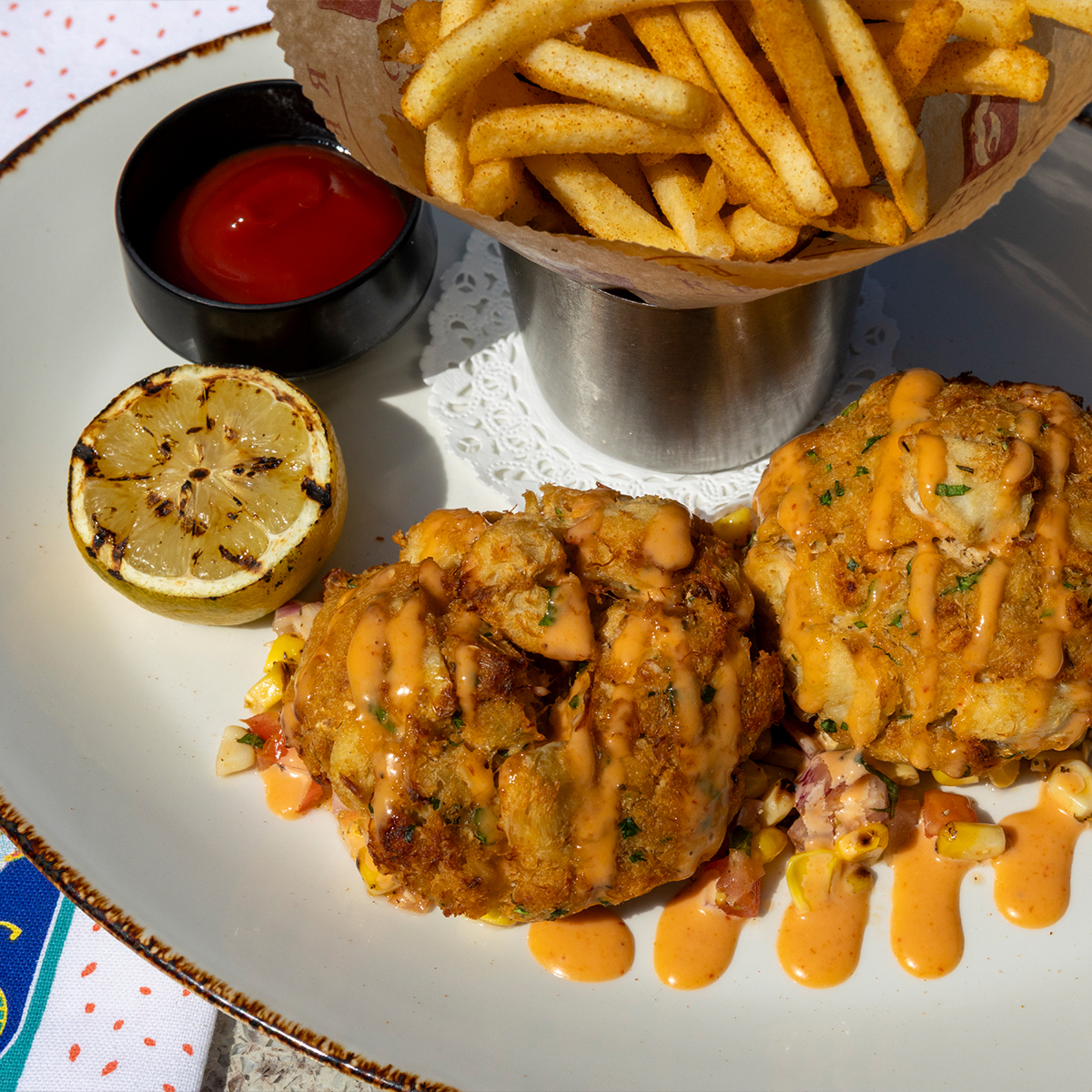 Crab Cakes | tomato corn salad, sriracha aioli, served with old bay fries