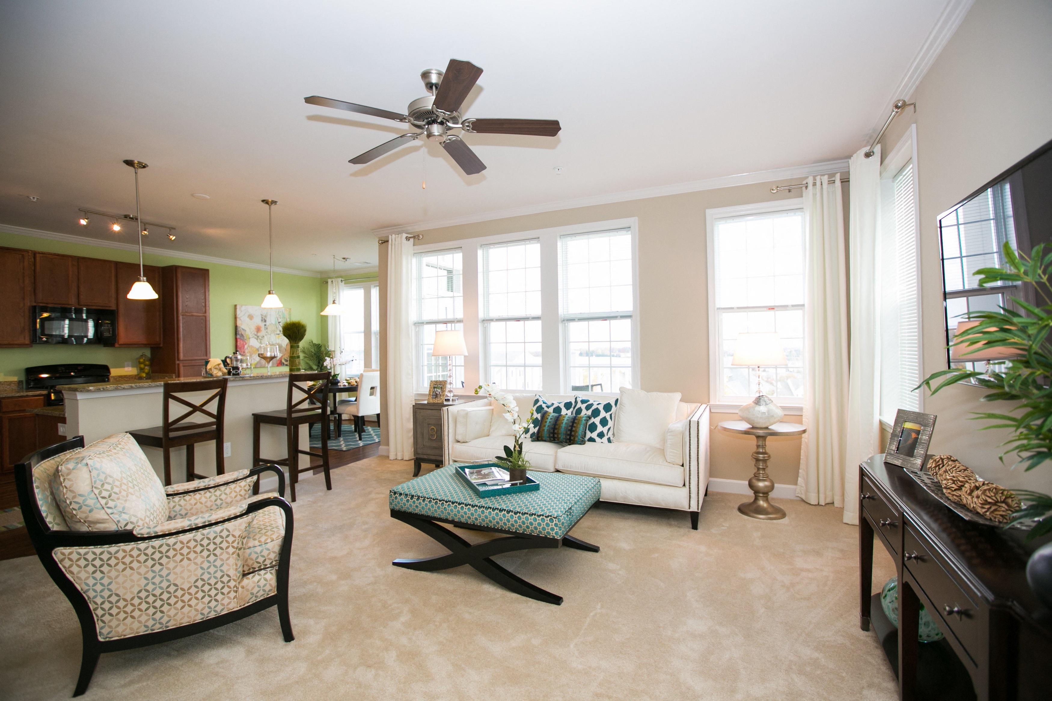 open concept living room with plush carpeting and large windows