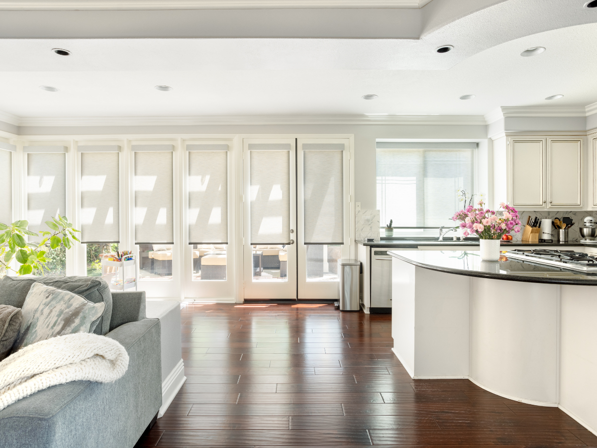 Roller shades installed in a bright, open kitchen space