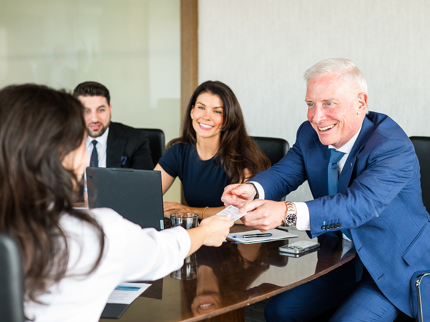 Sarah Troyer, Jordan Sanders, and David Campeau with a client in a meeting room.