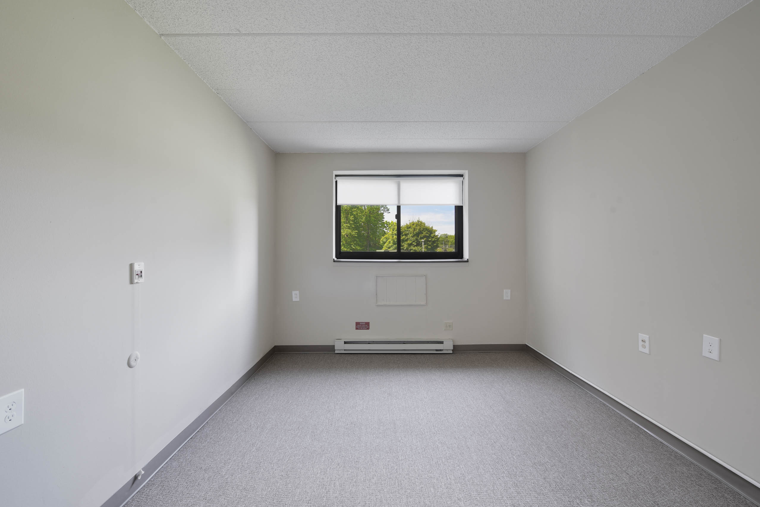 A room with a window and a door.