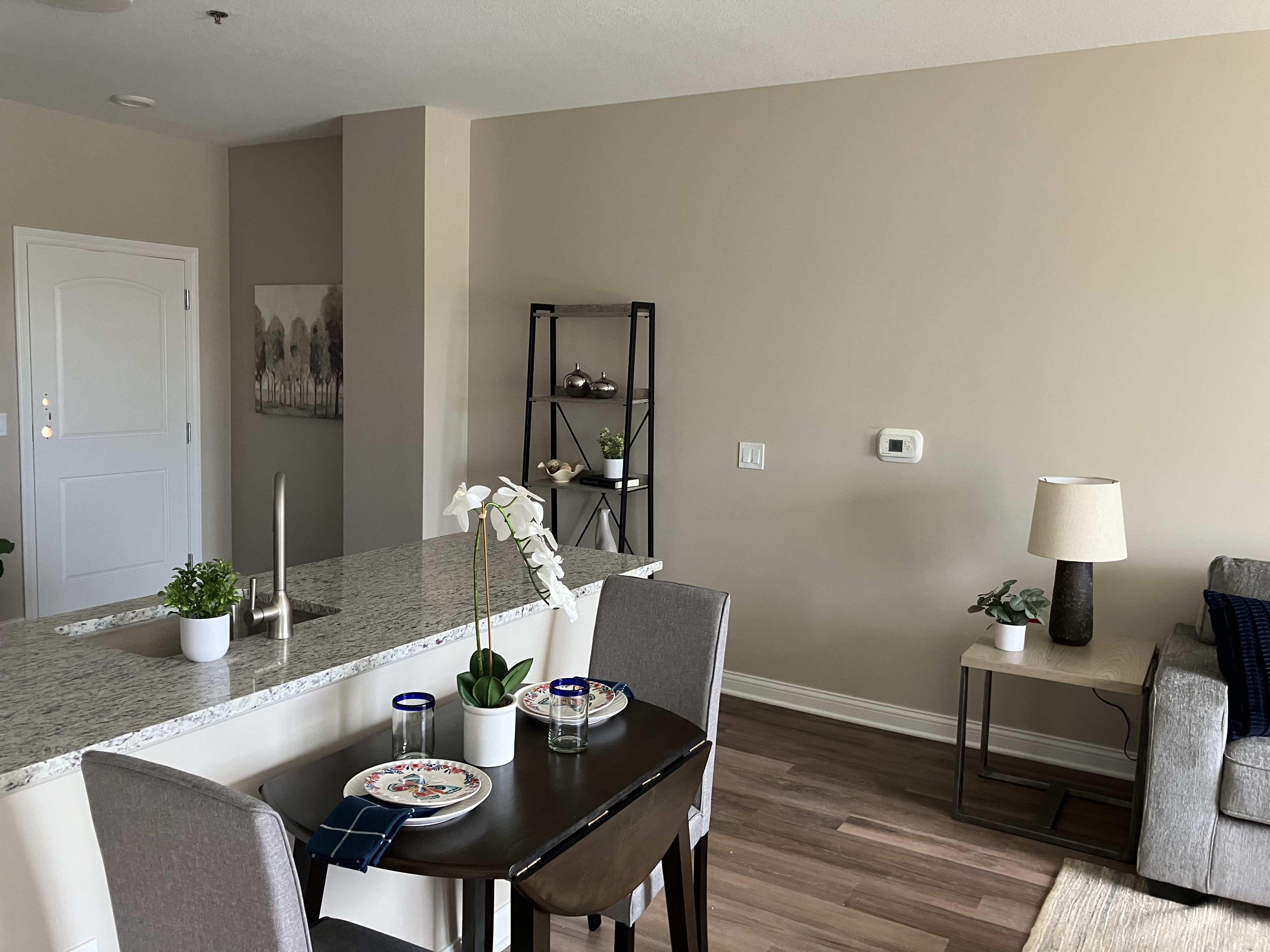 Residence kitchen, dining room, and living space at Twin Towers Senior Living Community.