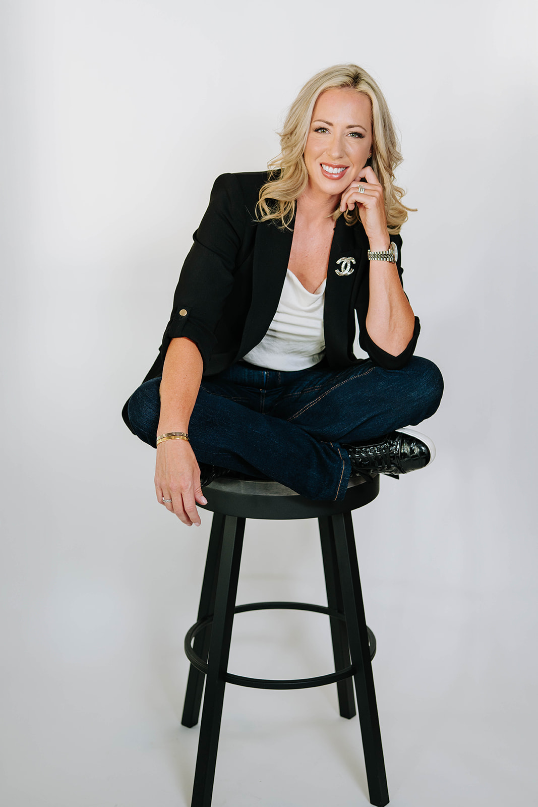 Photo of Caitlin Burton sitting on a bar height stool.