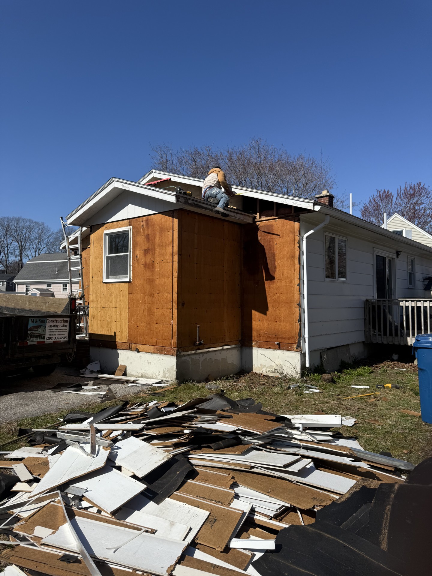 Residential home addition project featuring structural framing and exterior construction work completed by M & Son Construction.
