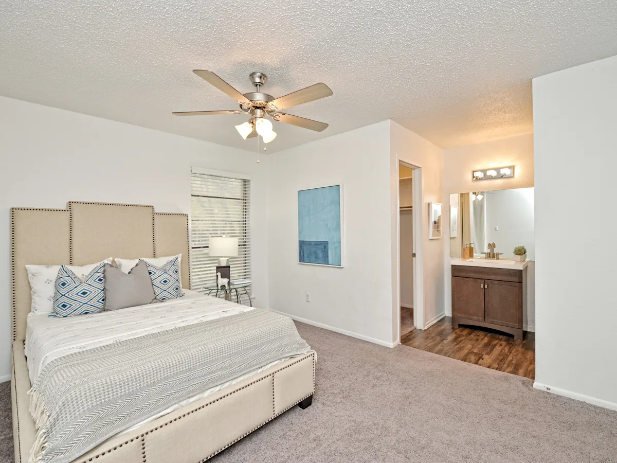 a bedroom with a bed and a ceiling fan