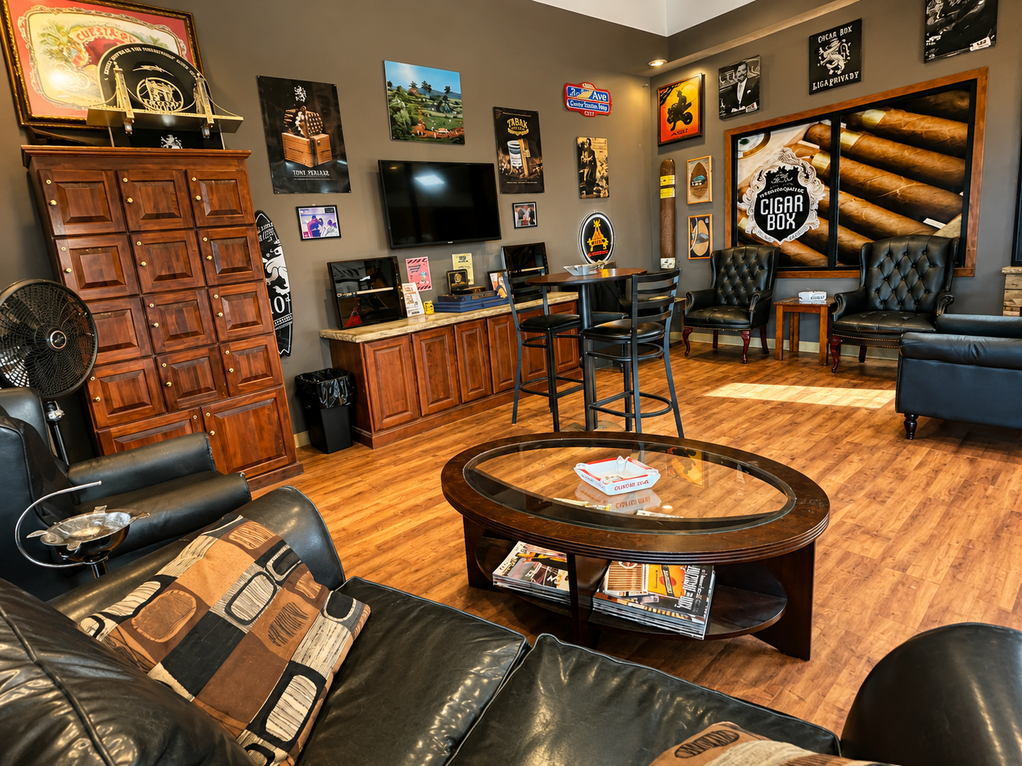 Relax in the inviting lounge at Tom Trella, featuring comfortable leather seating, premium cigar décor, and a welcoming atmosphere designed for cigar enthusiasts. This spacious interior showcases a clean, upscale environment where customers can browse, unwind, and enjoy an exceptional in-store experience.