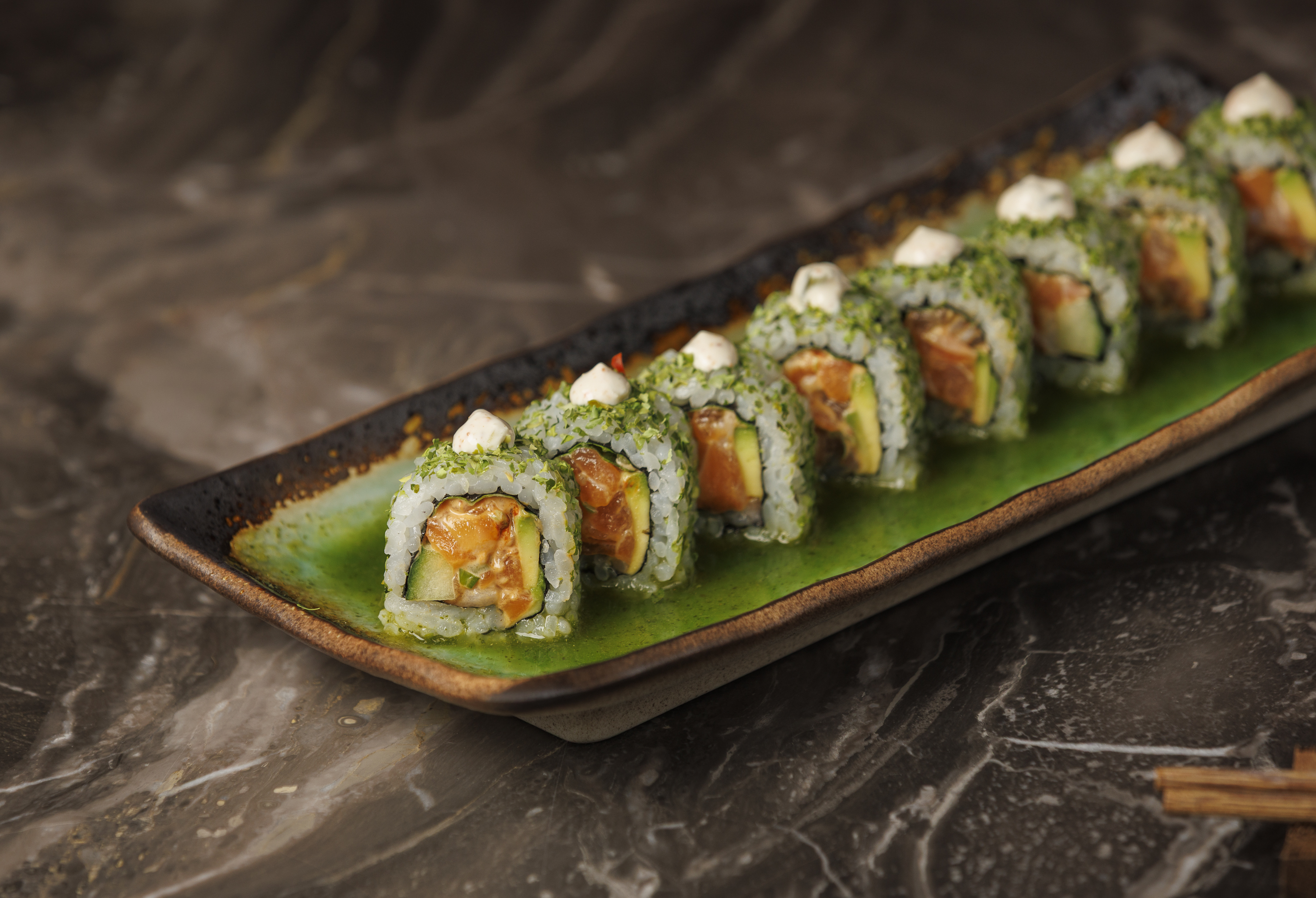 Mr. H Jade Roll sushi featuring spicy salmon, avocado, cucumber, jalapeño ponzu, wasabi crema, and f 