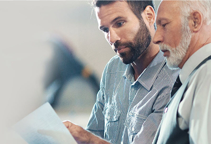 A son and father reviewing documents together.