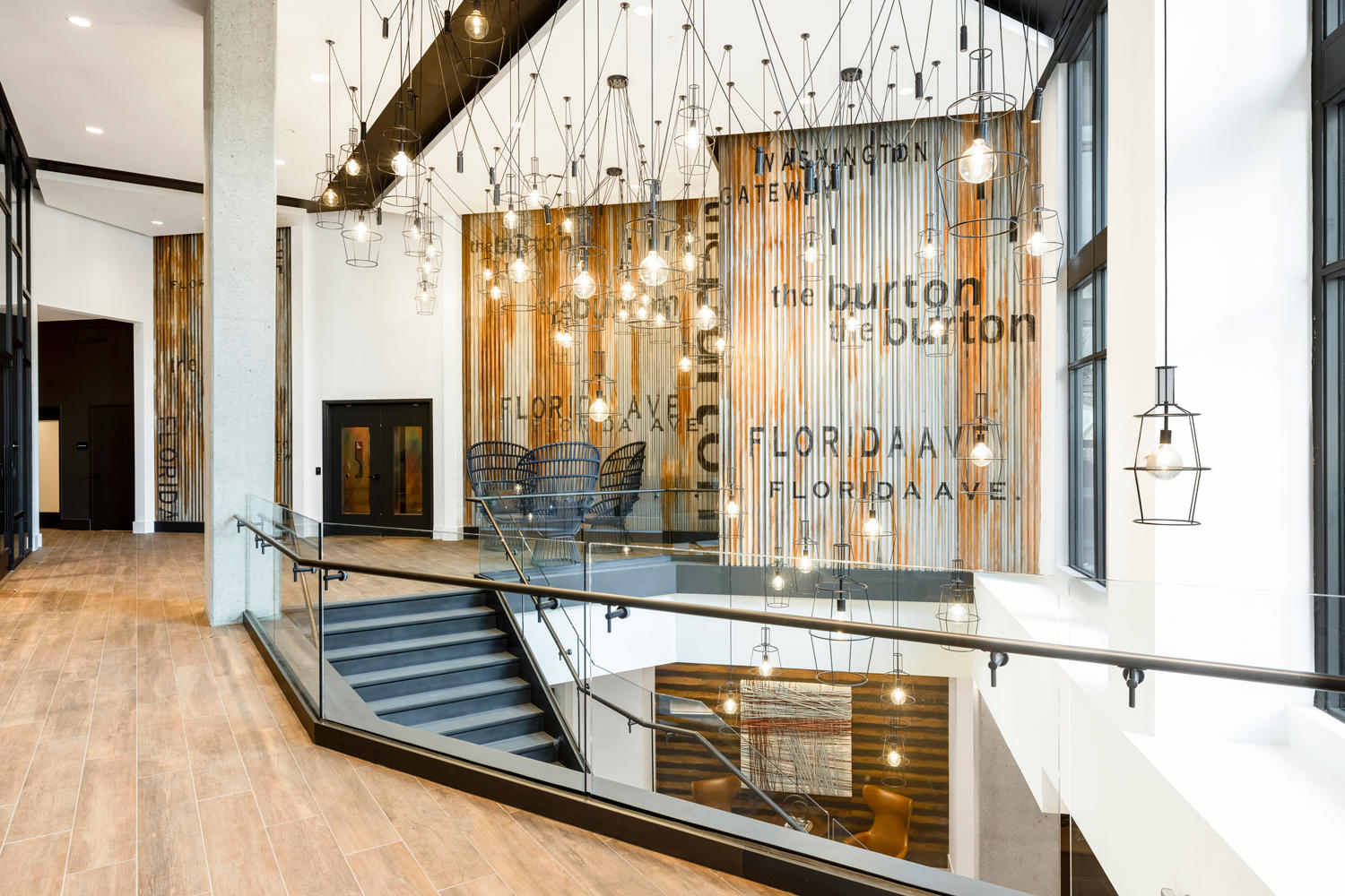 Industrial upper lobby with luminous, dripping light fixtures.