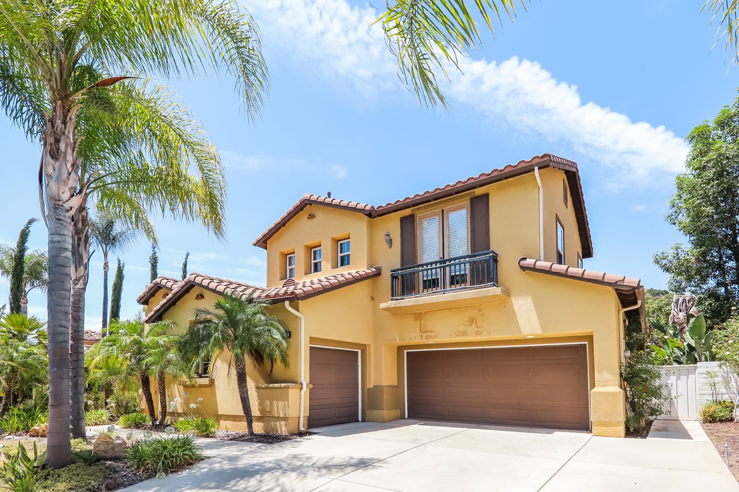 Front of home with double doors, three-car garage, and large driveway Invitation Homes Pasadena.