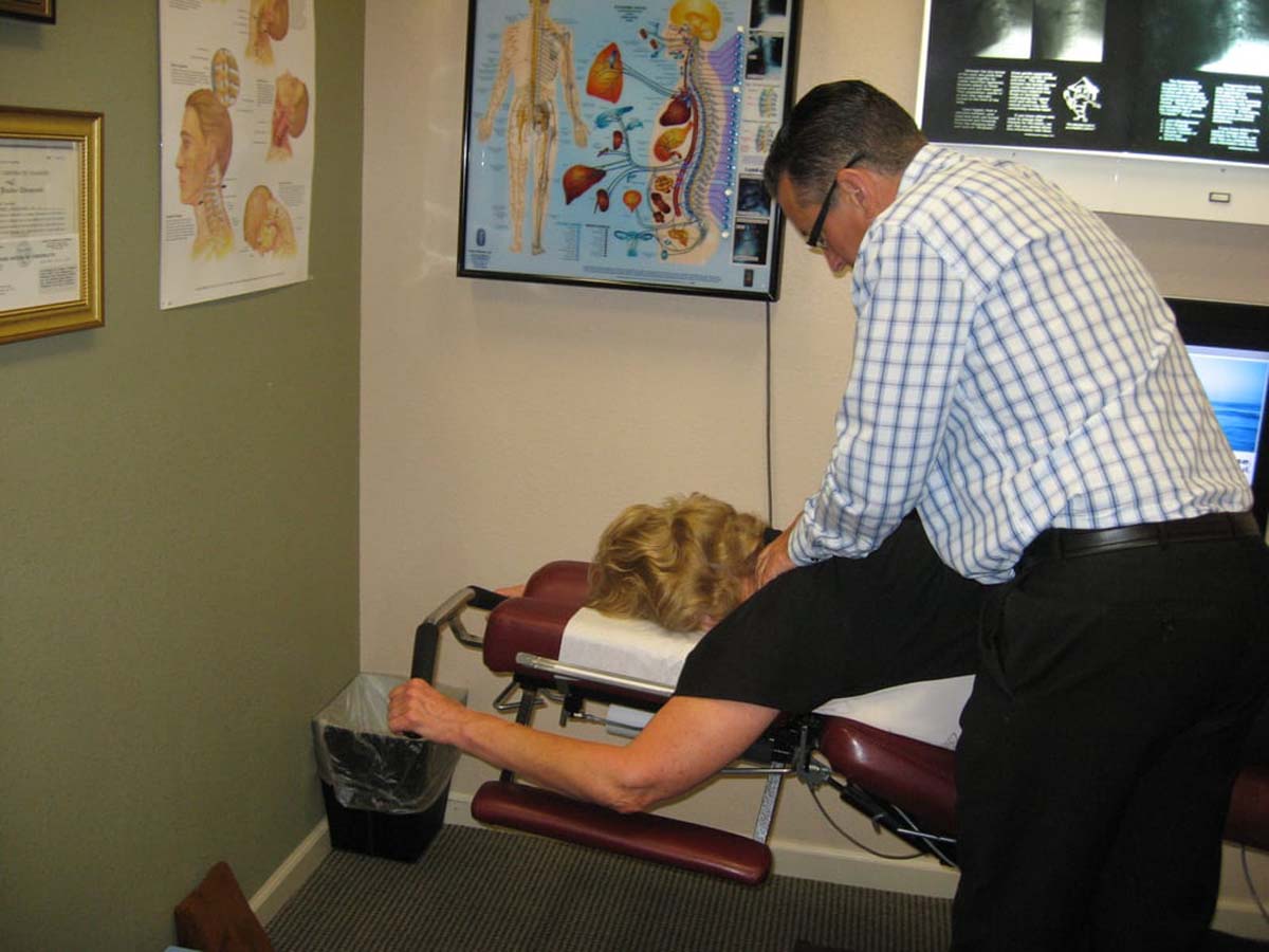 Dr. Pontious performing neck adjustment on Leander Table.