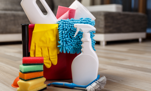 Bestwork Supply Center Cleaning supplies including sponges, gloves, a spray bottle, and brushes in a bucket, ideal for janitorial and sanitation needs."