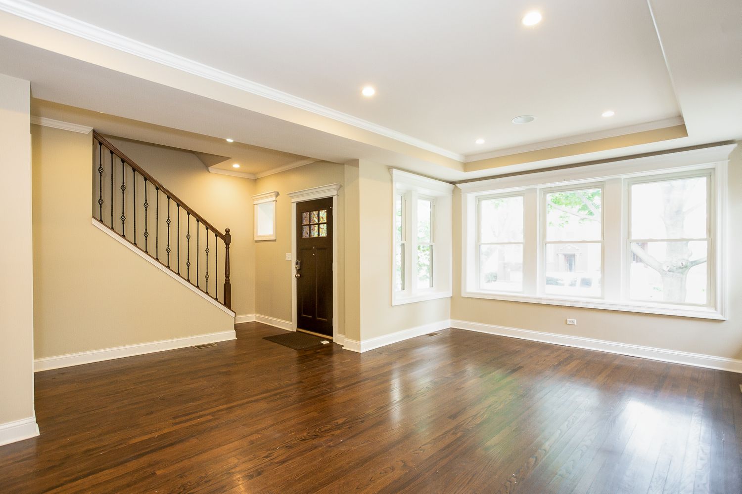 Spacious living area with natural light and a high ceiling at Invitation Homes Chicago.