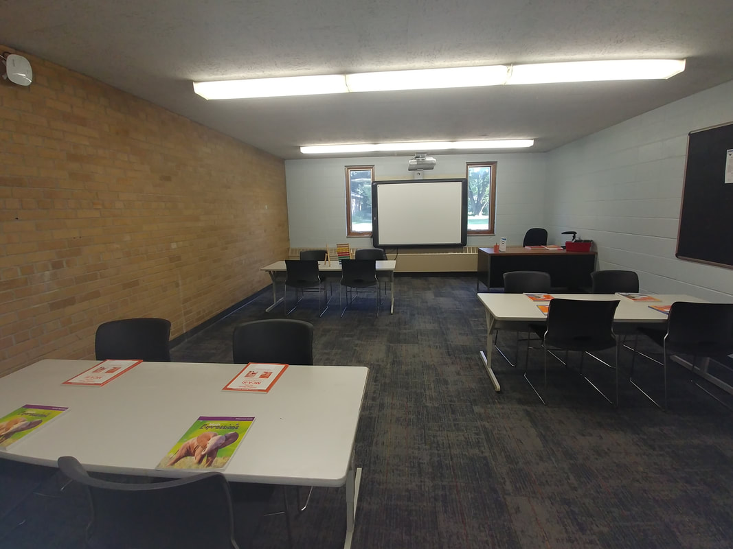 A spacious learning environment at Progeny Academy designed to foster student engagement, critical thinking, and academic growth. This well-equipped classroom features technology-enhanced instruction areas and flexible workspaces that support high-quality education for students in grades K-8 at the tuition-free public charter school in Brooklyn Center, Minnesota.
