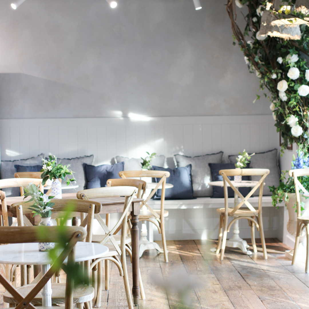 A sunlit seating area inside maman Park Cities offers a warm, comfortable space for breakfast, lunch 