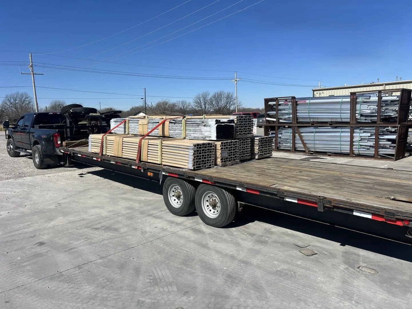 Flatbed trailer loaded with bundled construction materials showcases efficient logistics solutions,  