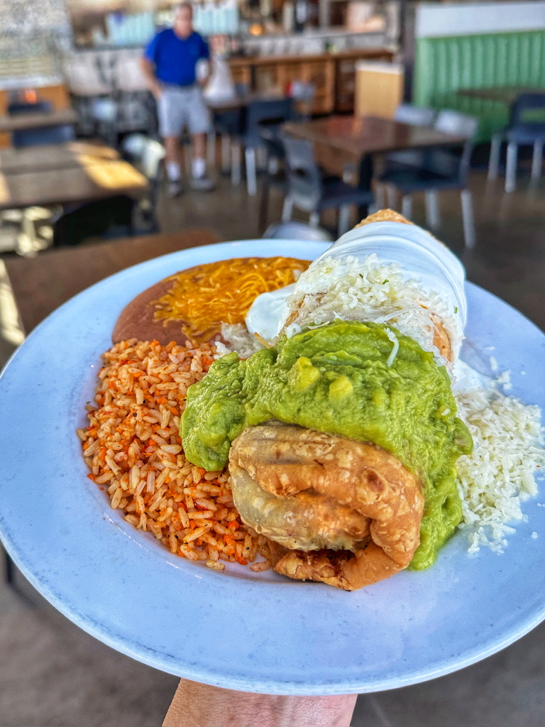 Deep fried chimichanga or pollo fondito topped with house made guac, sour cream, cheese and plated w 