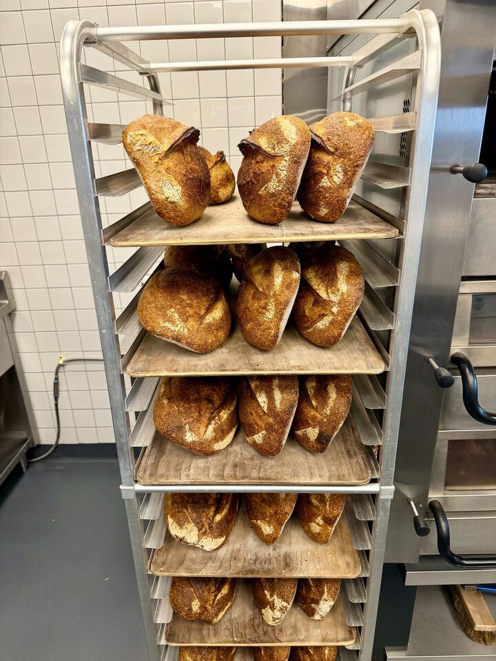 Naturally leavened sourdough loaves cool on a bakery rack in the Folk kitchen in East Nashville. 