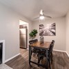 Dining area with ceiling fan and artwork