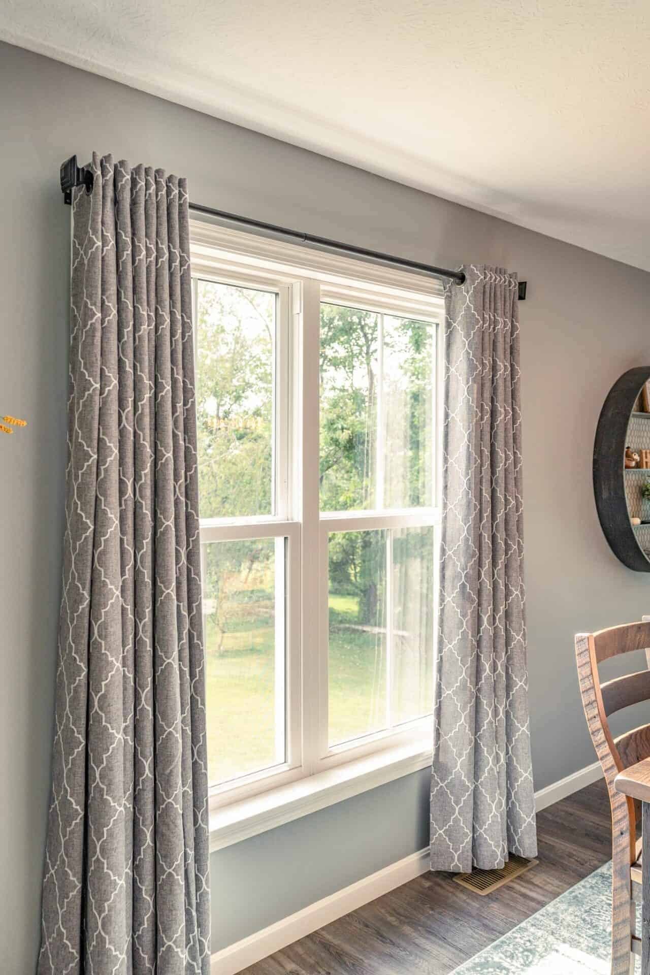 The EcoTek 3200 Series Double-Hung Windows enhances this living space with natural light and energy efficiency. The sleek design pairs well with the neutral-toned walls and elegant drapery, creating a bright, inviting atmosphere perfect for relaxation and comfort.