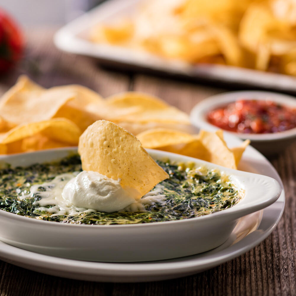 Santa Fe Spinach Dip: Prepared with creamy cheese, topped with sour cream and served with freshly fr Cheddar's Scratch Kitchen Lexington (859)272-0891