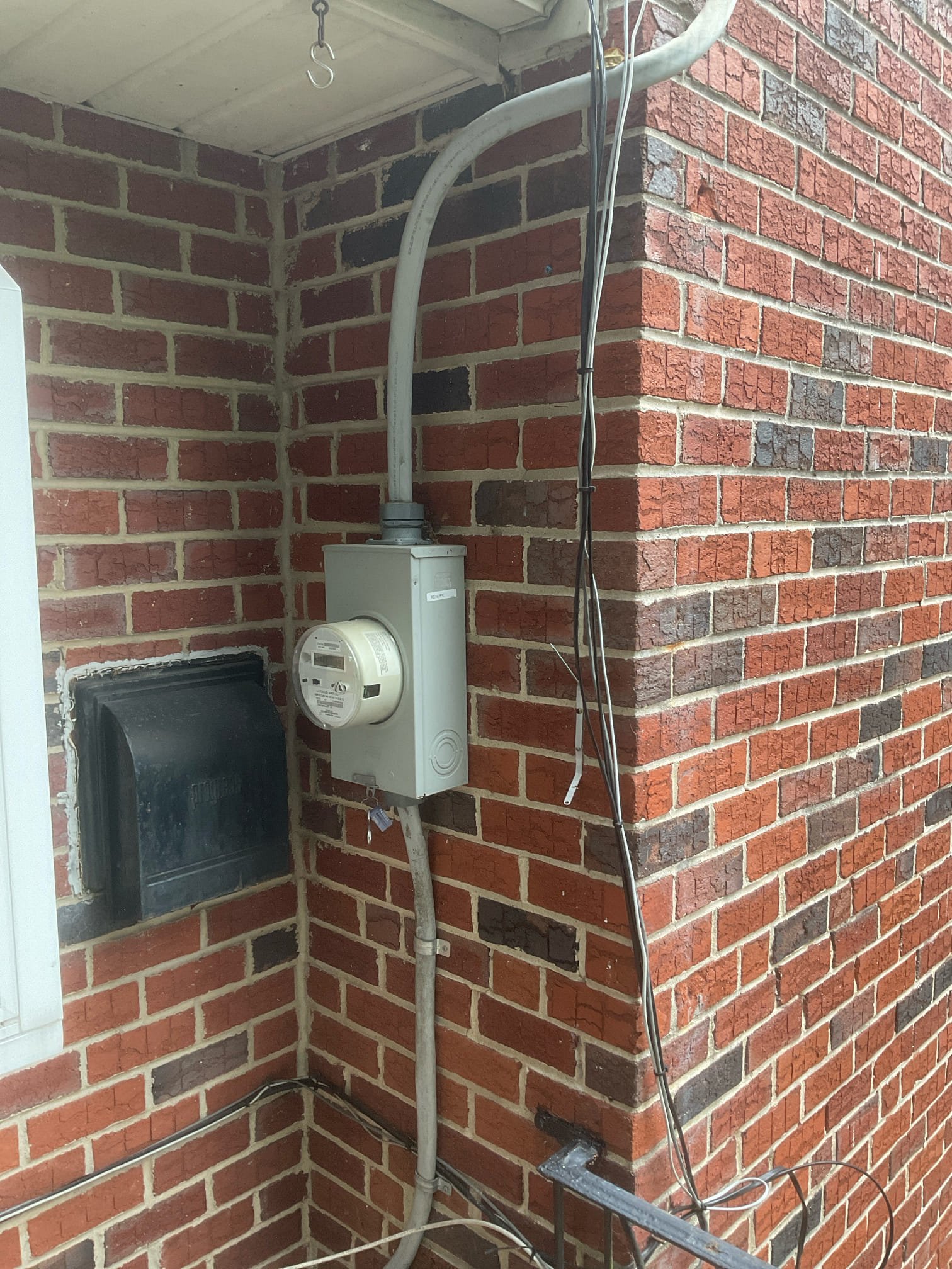 Thomas Edison Electric serviced the exterior meter base and service entrance at a Jenkintown, PA brick rowhome. The weatherhead, conduit, and meter enclosure connect the overhead utility feed to the home's electrical system.
