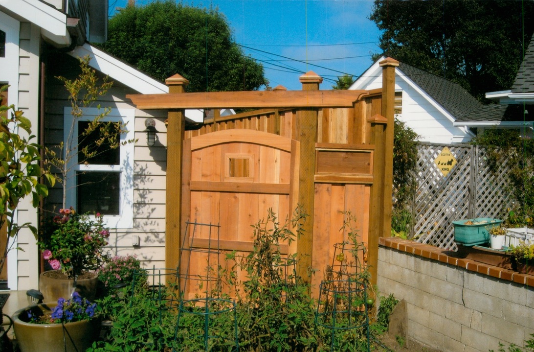 Wood privacy fence with a matching gate, adding secure access and natural curb appeal to a residential yard.