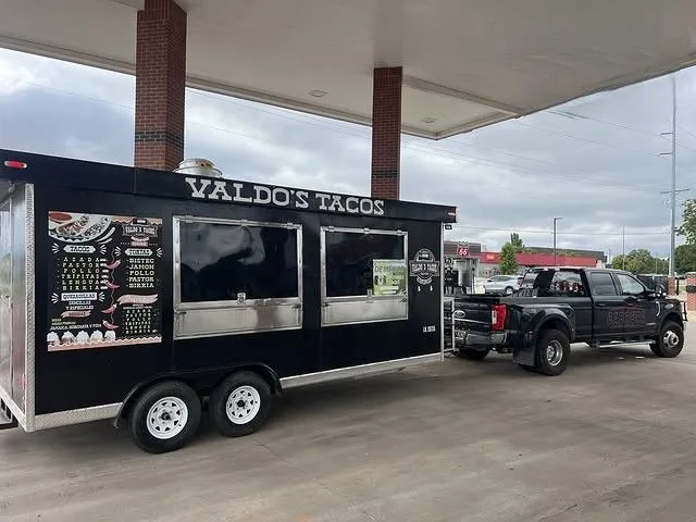 Commercial food trailer is safely transported by a heavy-duty pickup truck, showcasing specialized h 