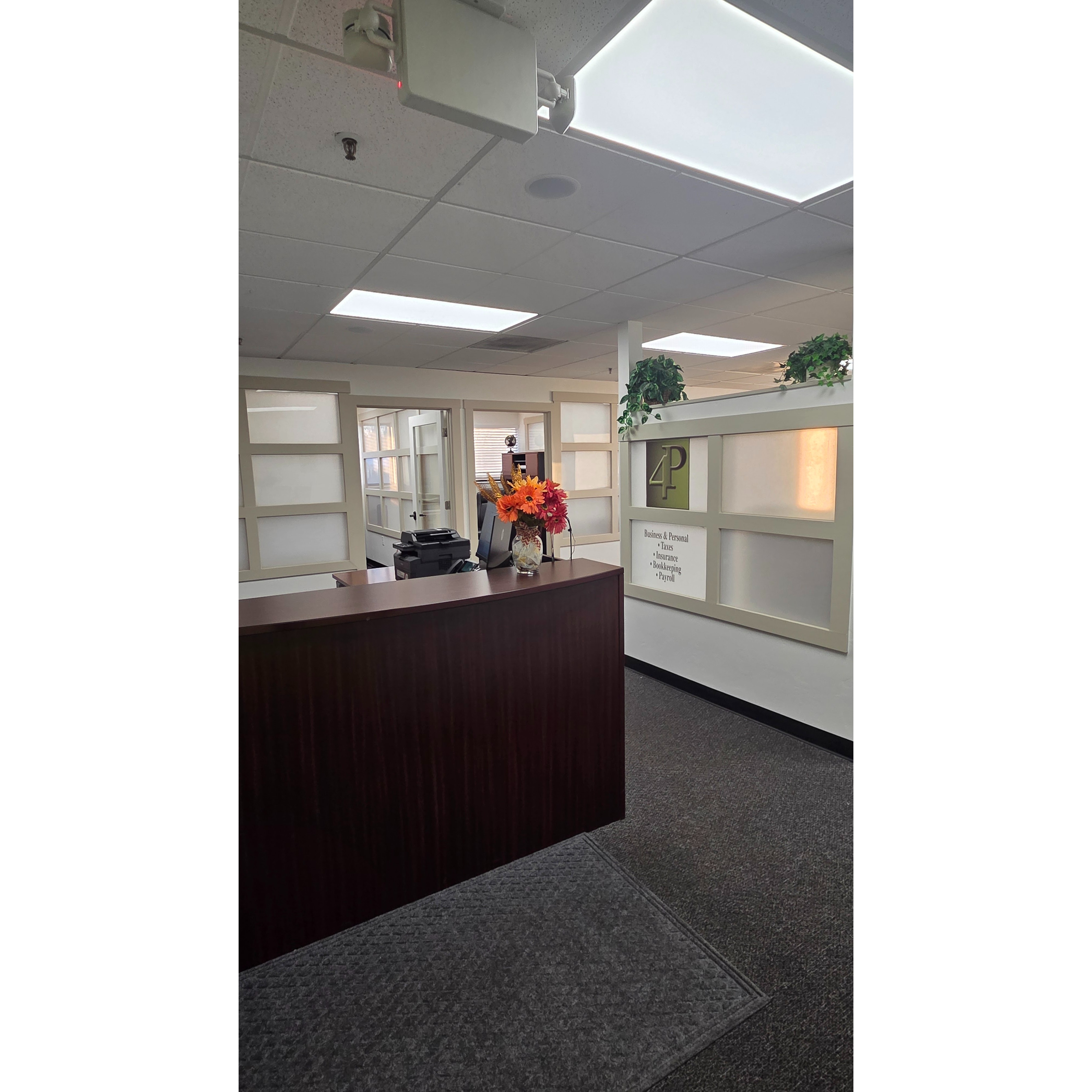 Inside 4P Taxes office, showing the front desk and workspace where the team assists clients with income tax preparation, business tax services, payroll, bookkeeping, and bilingual customer support.
