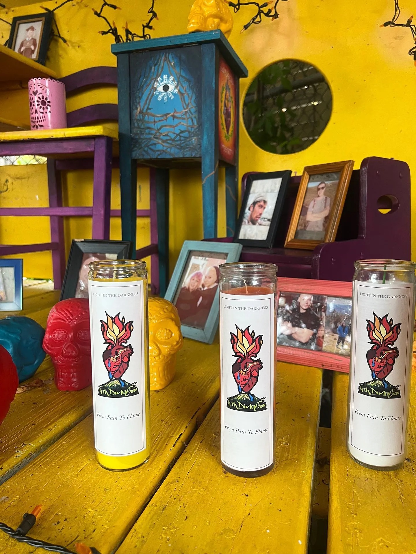 Decorative remembrance display featuring memorial candles, colorful handcrafted furniture, framed photographs, symbolic artwork, and vibrant d&eacute;cor honoring loved ones while celebrating healing, remembrance, hope, recovery, and meaningful community connections together.