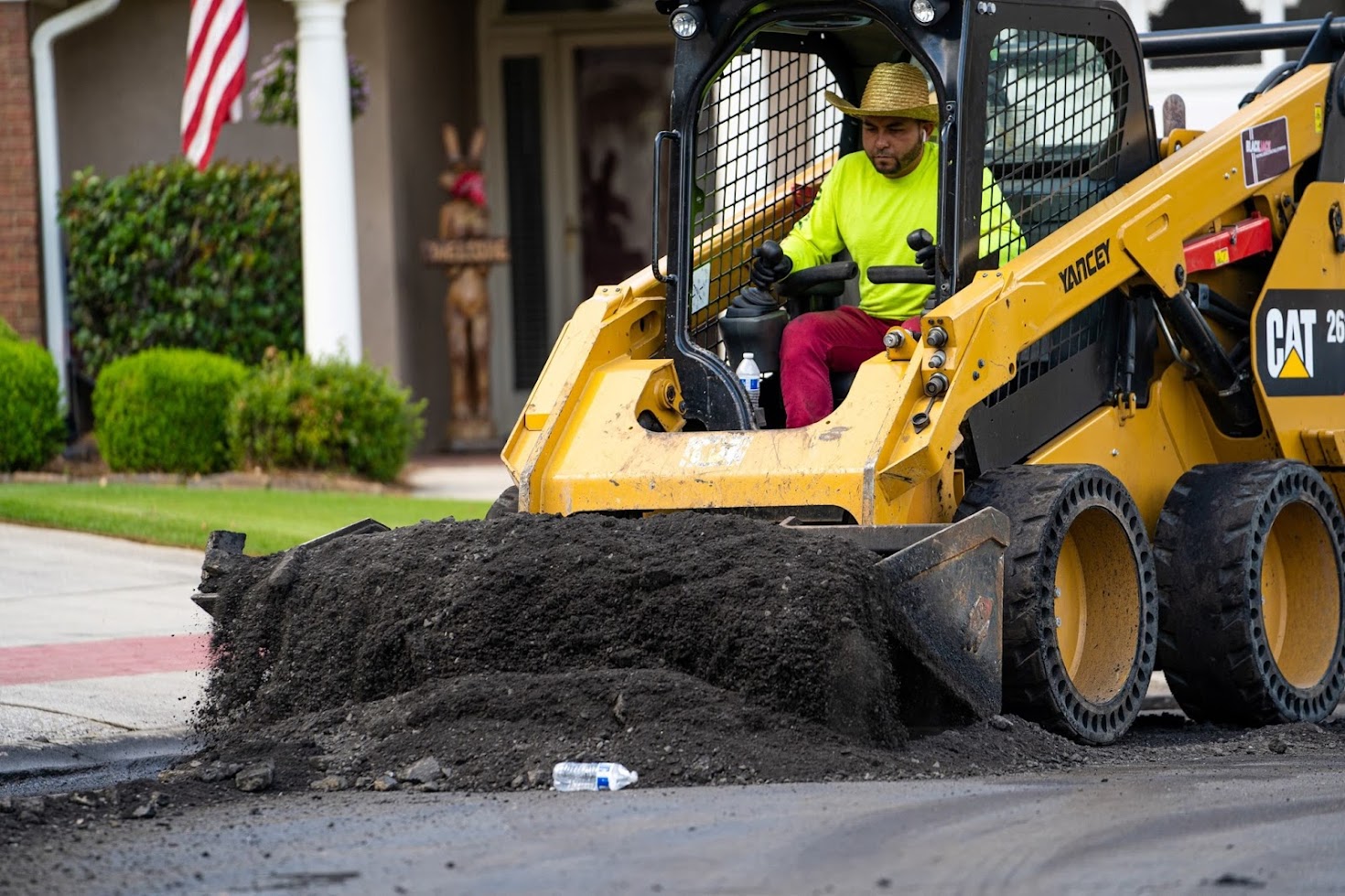 Man performing asphalt paving in street