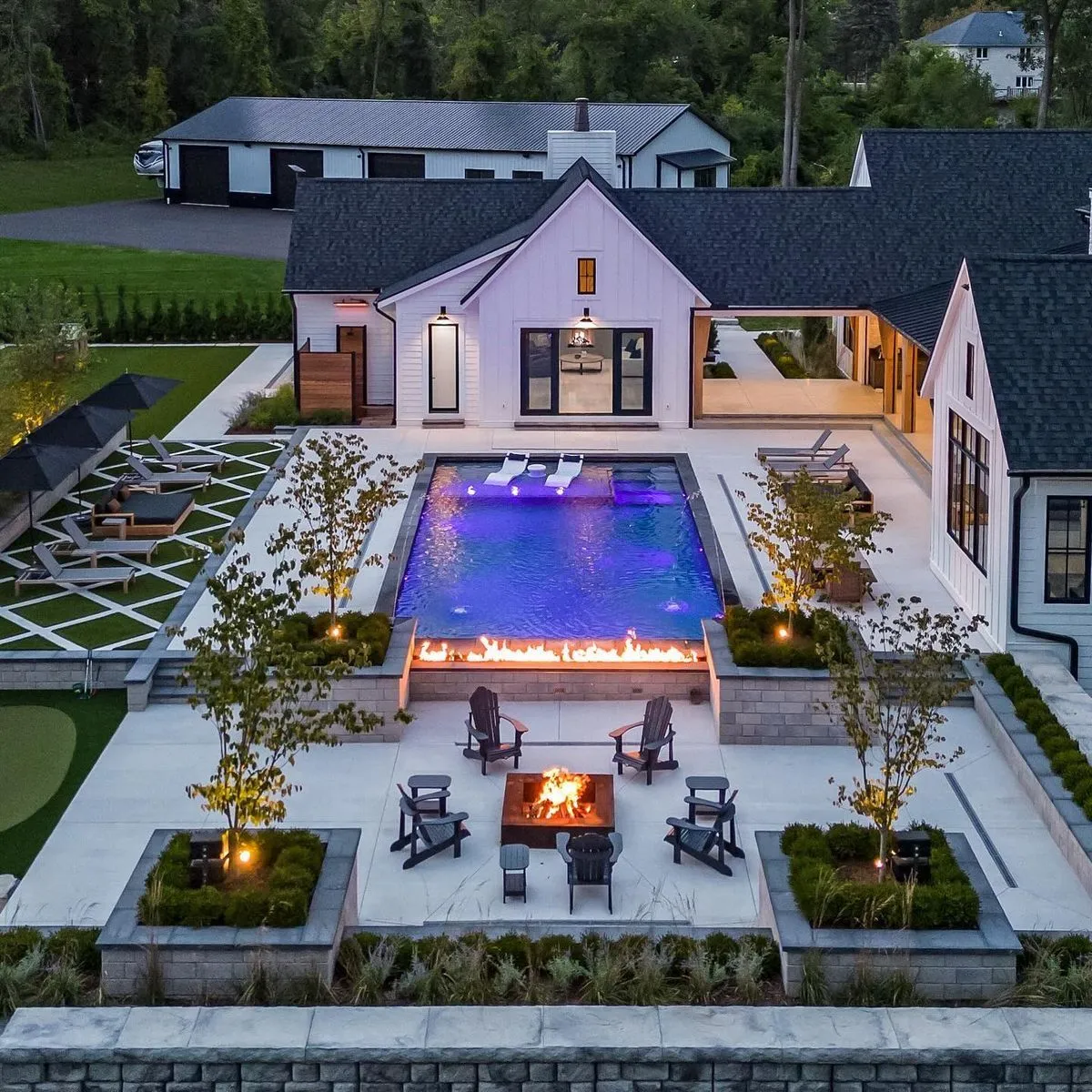 This aerial view highlights Zamora Design and Build's expertise in creating sophisticated outdoor living environments, showcasing their seamless integration of hardscaping, water features, and cozy gathering areas.