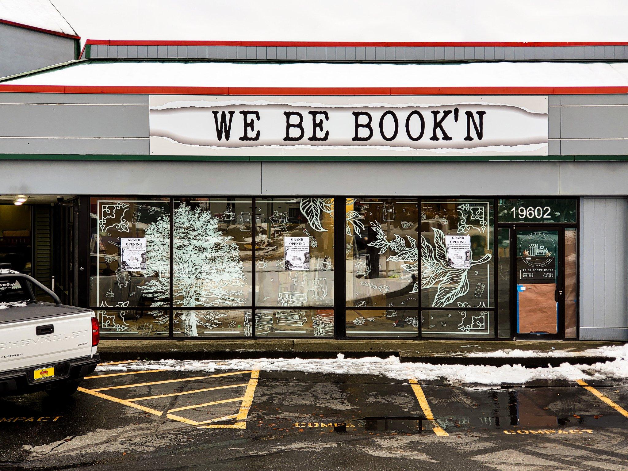 White decorative botanical window graphics for the We Be Book'n storefront, printed and installed by Ardor Printing.
