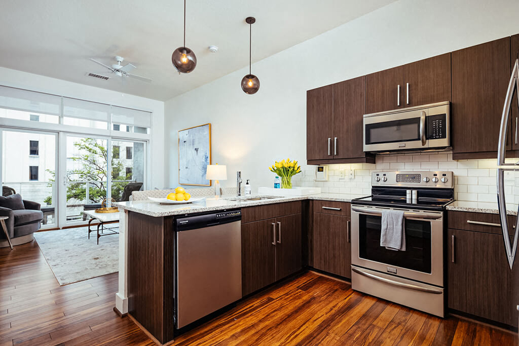 Kitchen island with granite countertop and pendant lighting