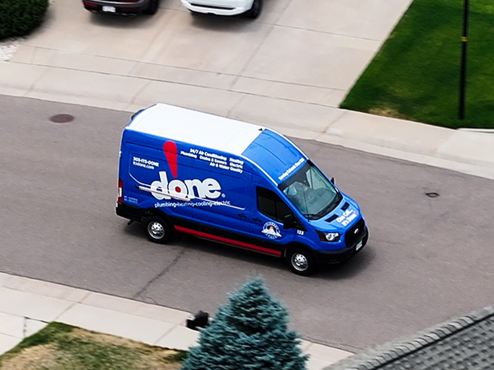 A Done Plumbing, Heating, Cooling and Electric truck driving on the road