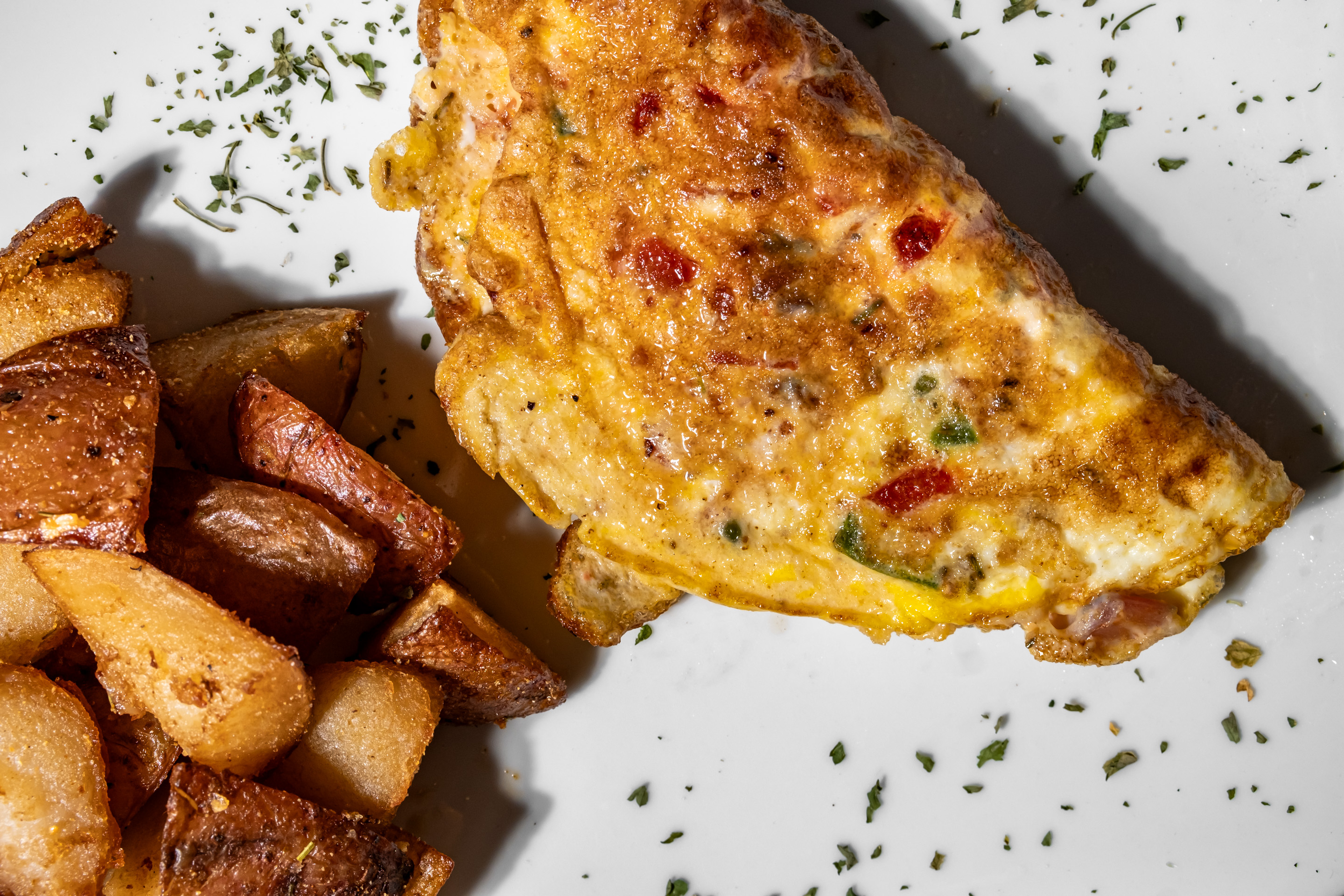 Fluffy three-egg omelette served with a side of sweet, glazed yams.