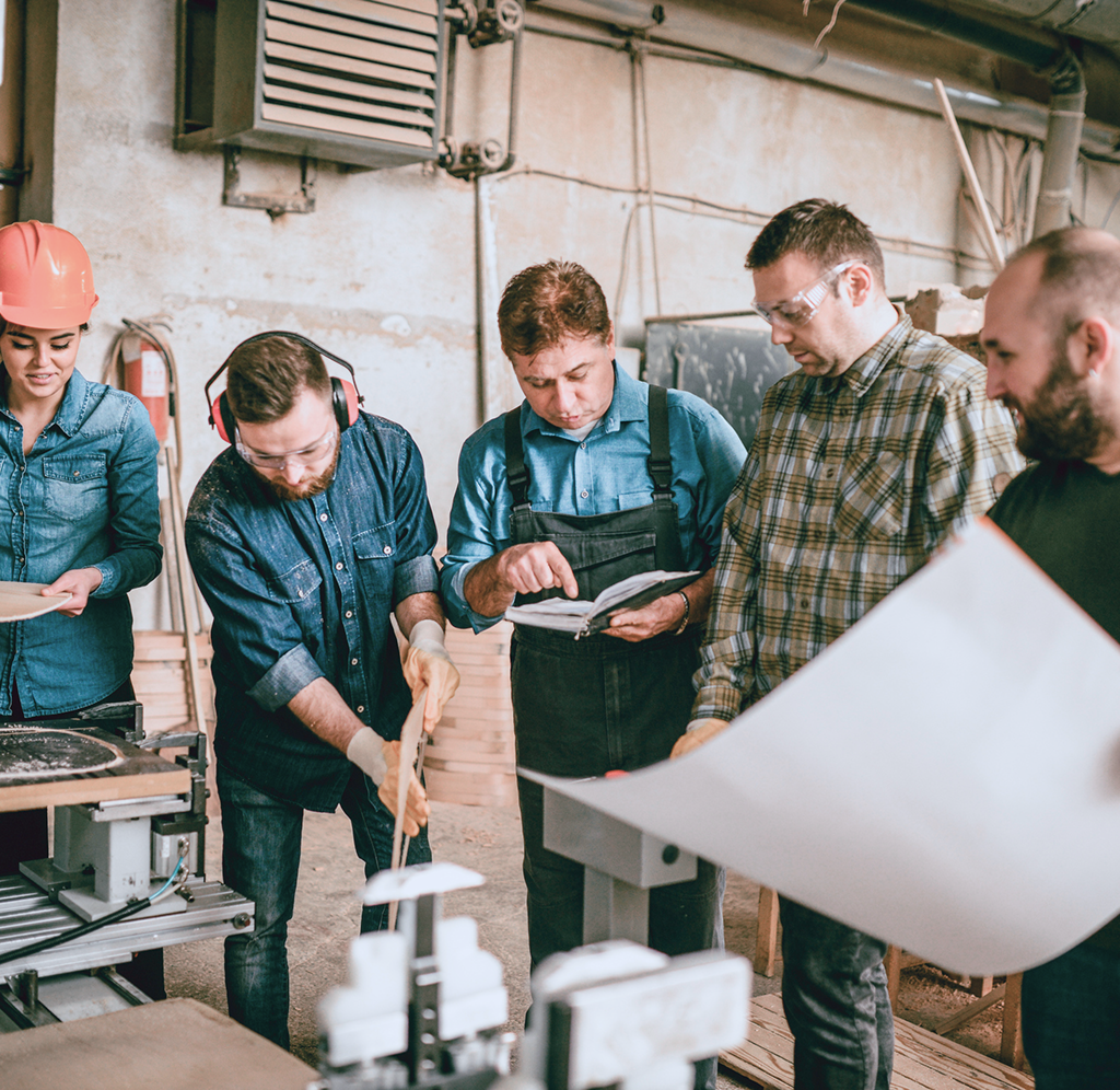 Business owners collaborating in a factory setting.