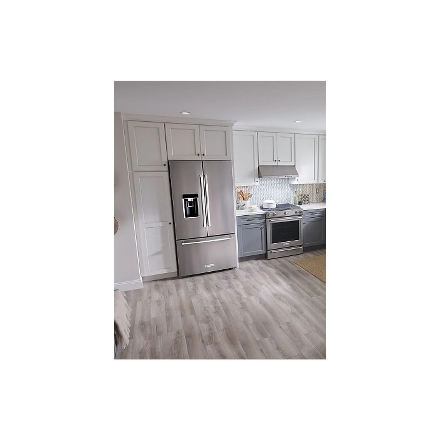 Modern kitchen featuring a stainless steel French door refrigerator installed within custom cabinetry, showcasing professional appliance fitting, seamless integration, efficient space utilization, and a clean contemporary design.