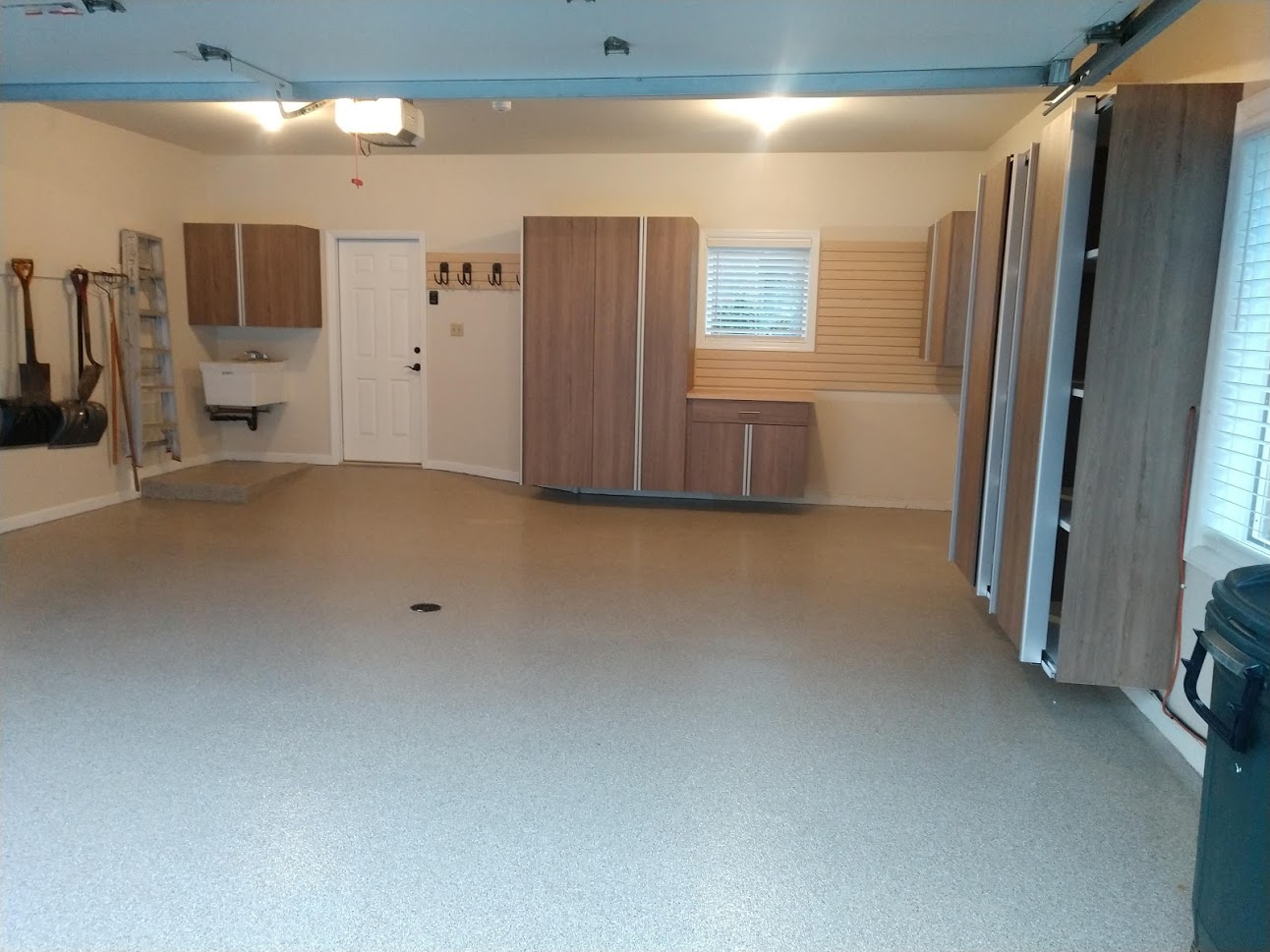 Complete Garage transformation with new epoxy floor, new custom cabinets, new slatwall