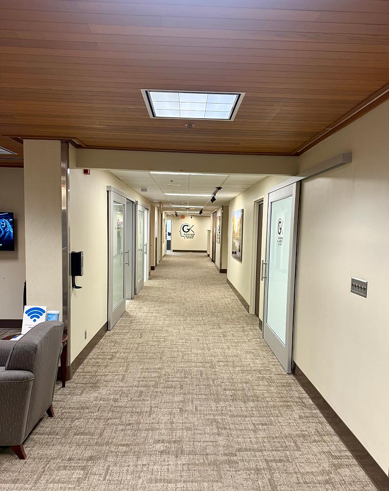 The central hallway provides access to exam rooms and radiation therapy treatment areas.