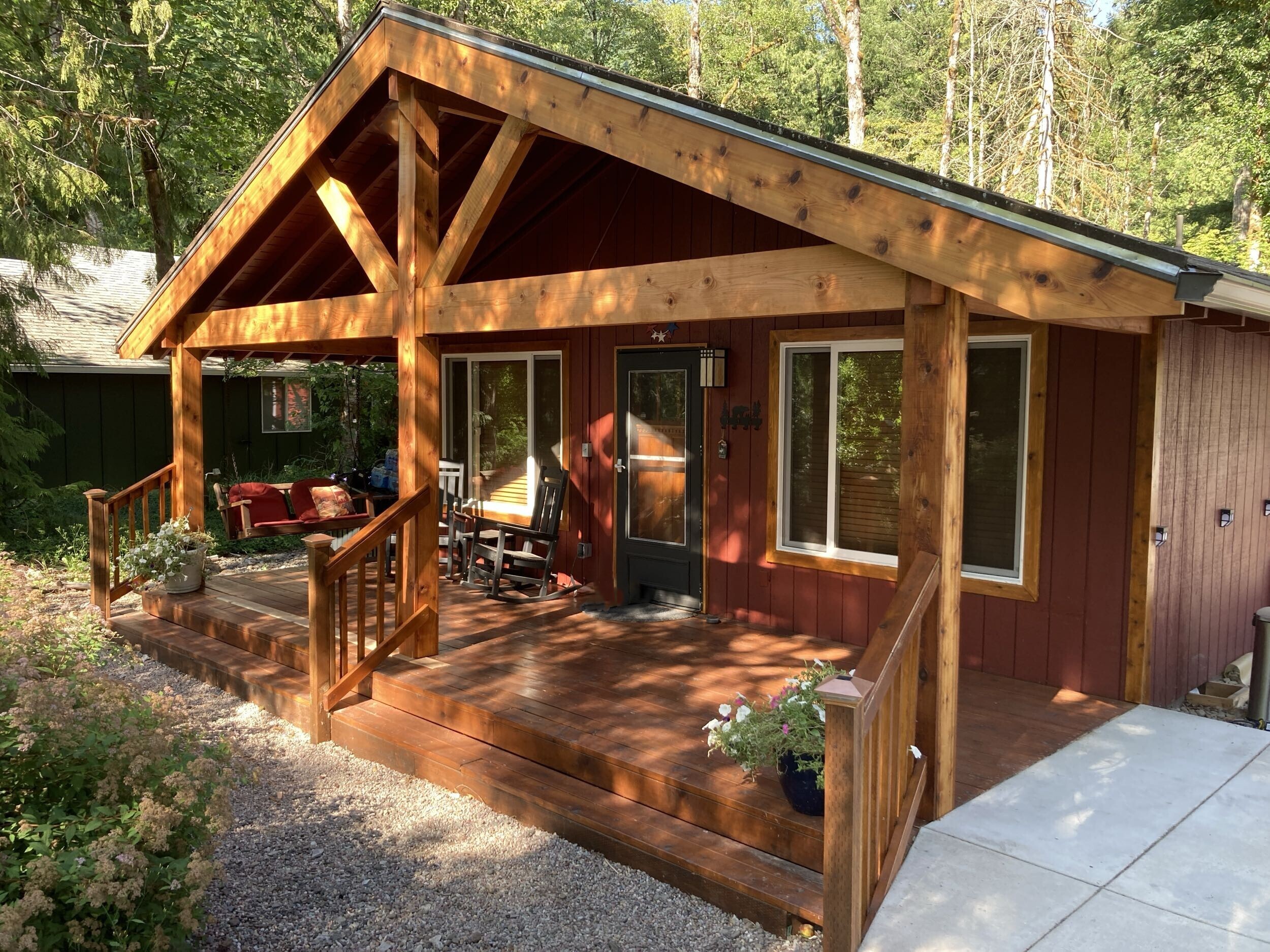 Custom home remodeling and covered front porch renovation completed by Jason Smith Construction in Clackamas County, Oregon. Beautiful Northwest-style home exterior featuring custom timber framing, wood beams, covered deck construction, siding upgrades, and detailed craftsmanship for homeowners in Canby, Oregon City, Wilsonville, Molalla, West Linn, and surrounding areas.