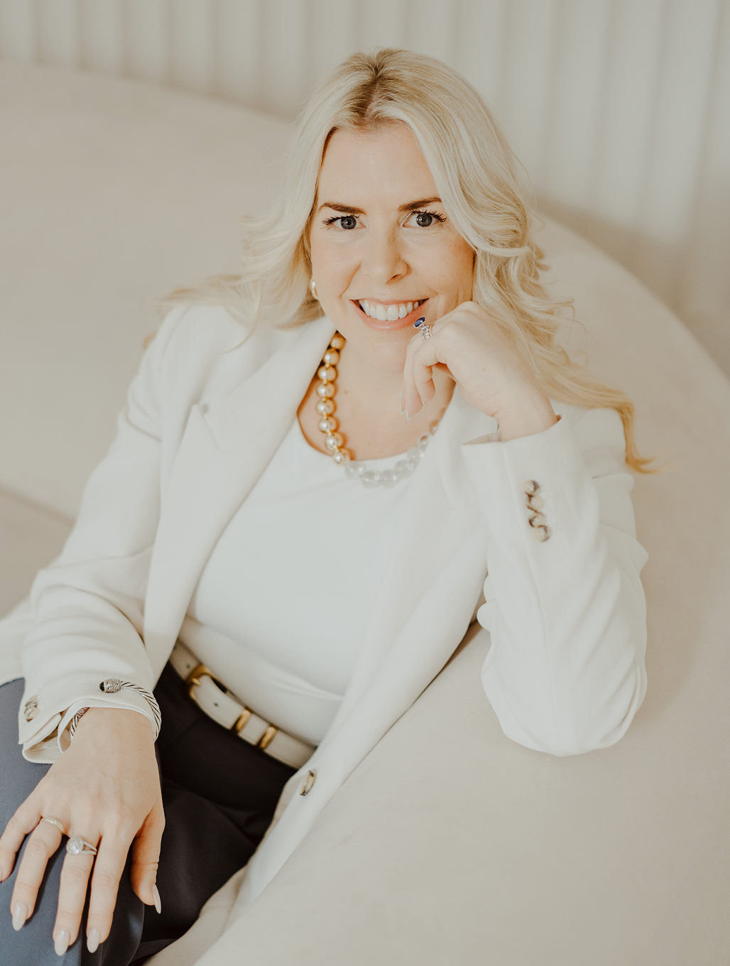 Kristine Mackay sitting on couch in page.