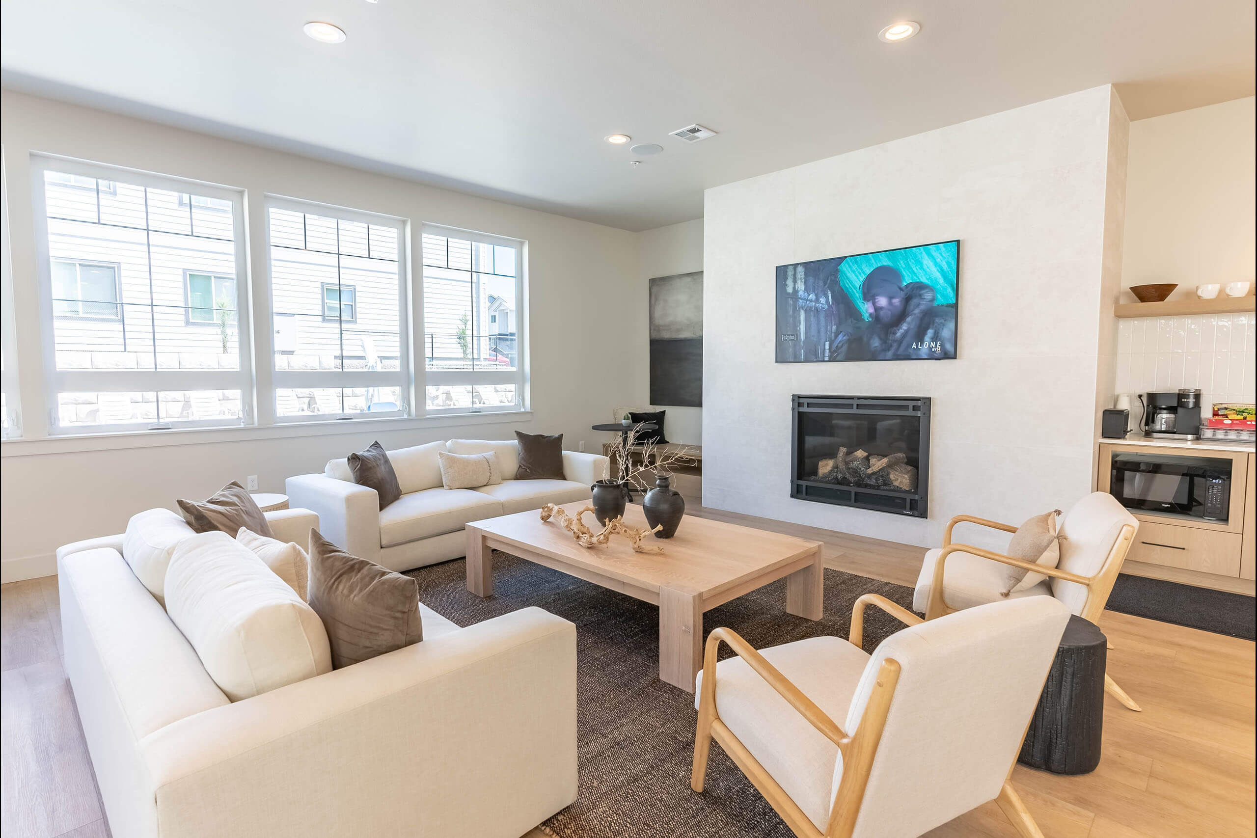 A modern living room with a fireplace and a television.