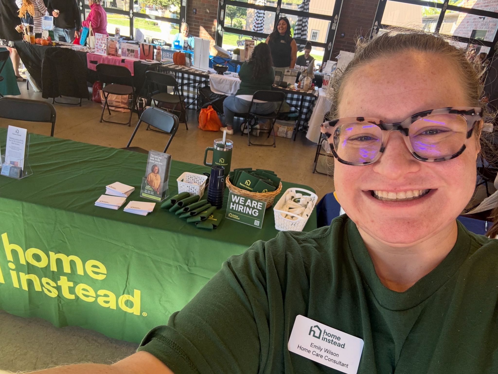 Home Instead representative providing resources and education to families at a local community event.