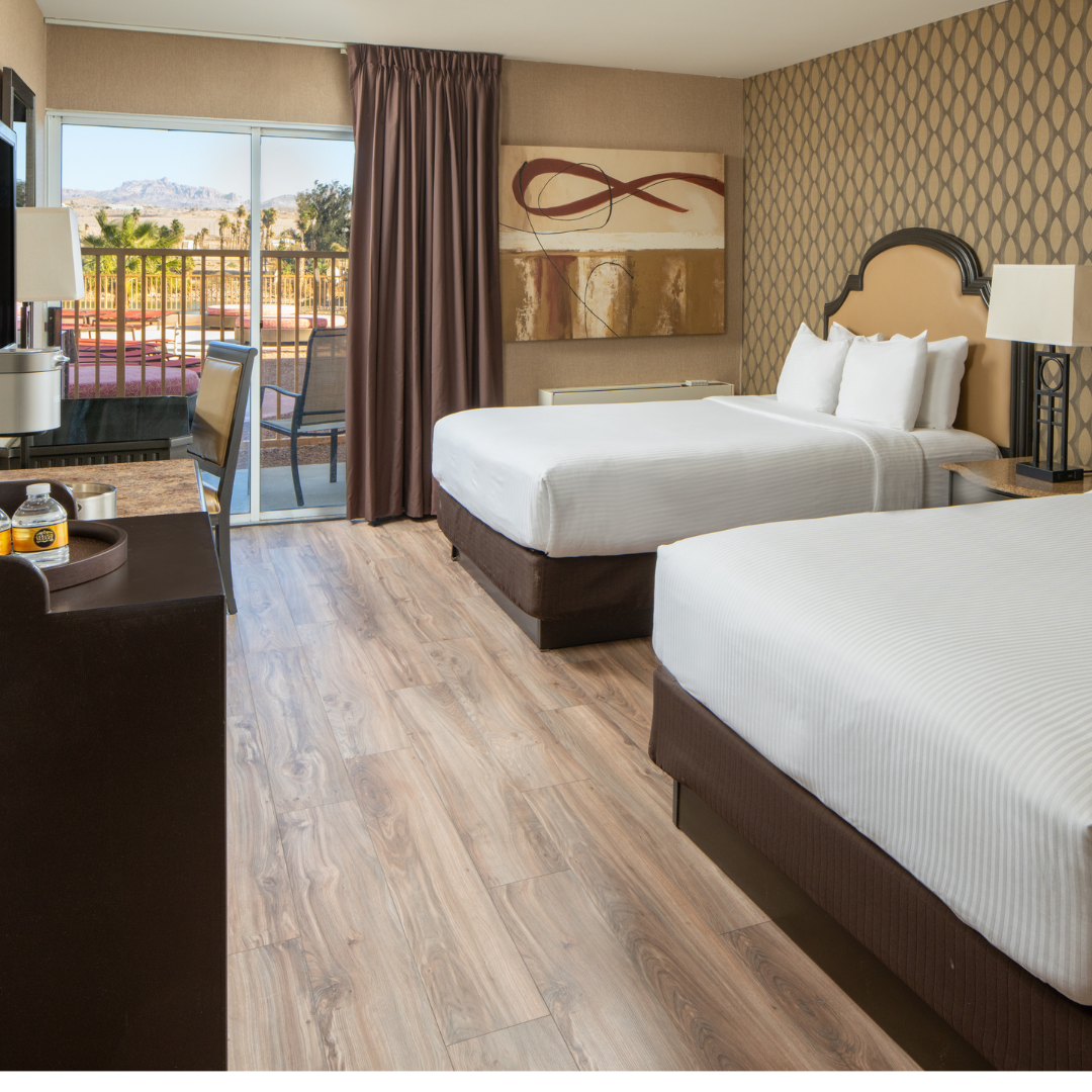 Modern hotel room with two queen beds and balcony view