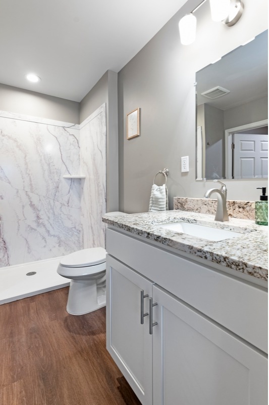 One of two full bathrooms in each Brookwood Estates of Taylor residence, featuring modern fixtures and accessible design for our 55+ active senior community.