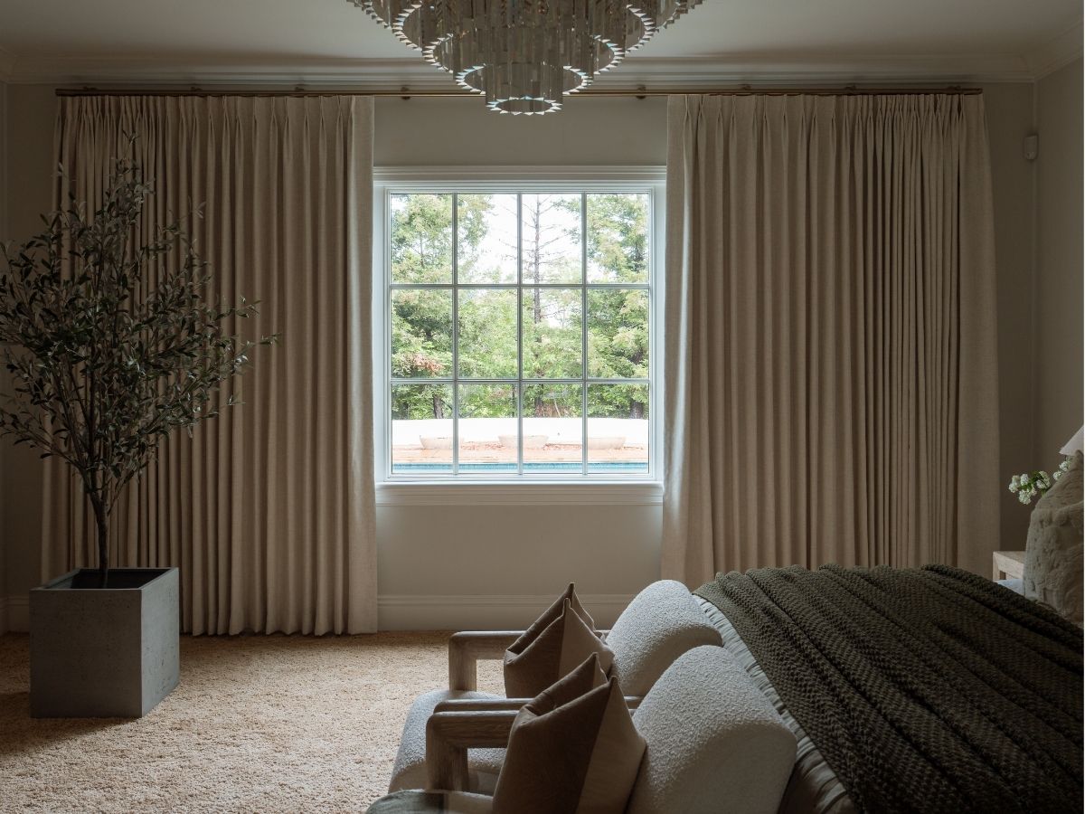 This motorized drapery, finished with a warm gold metal pole, adds custom style and effortless light control to a Mobile home. For Draperies in Mobile, our in-home experts help homeowners in neighborhoods from Spring Hill to Midtown find a custom fit that works beautifully in their space.