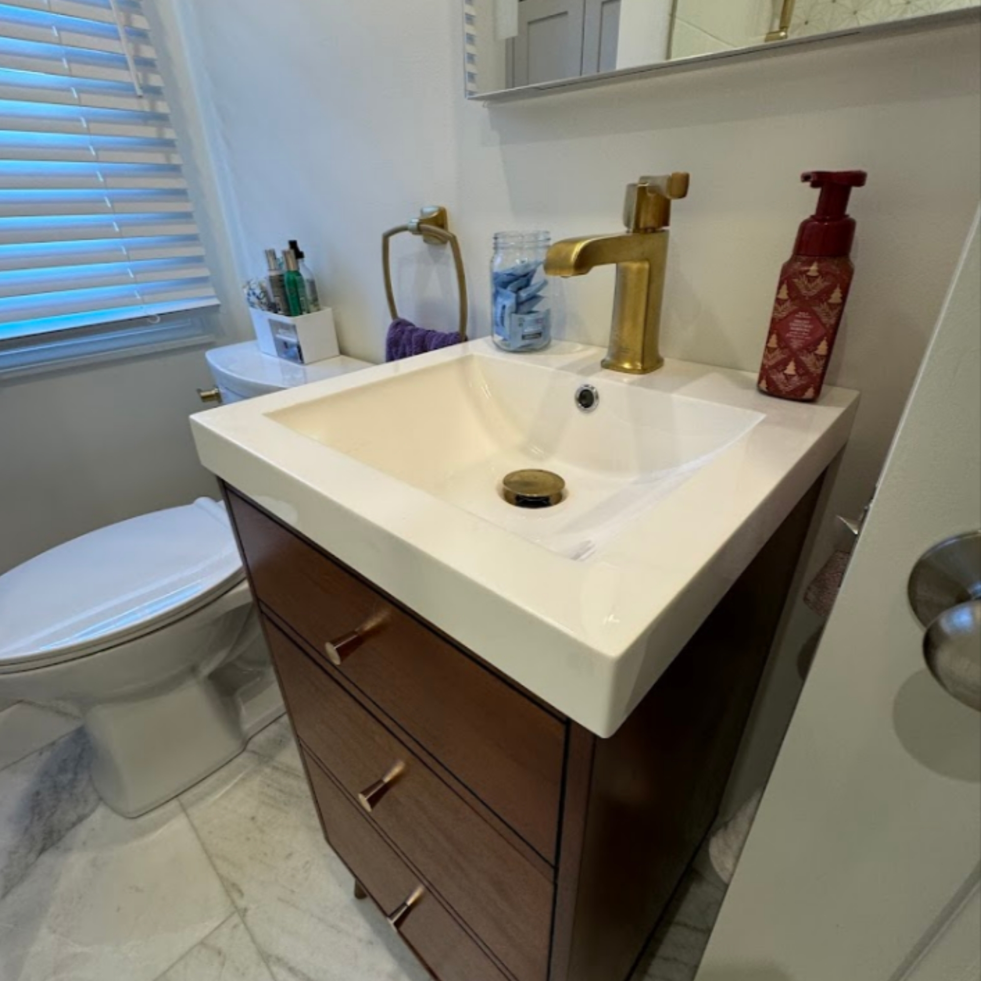 Compact bathroom vanity with a stylish sink, modern faucet, and elegant wood cabinetry. Designed for small spaces without compromising functionality.